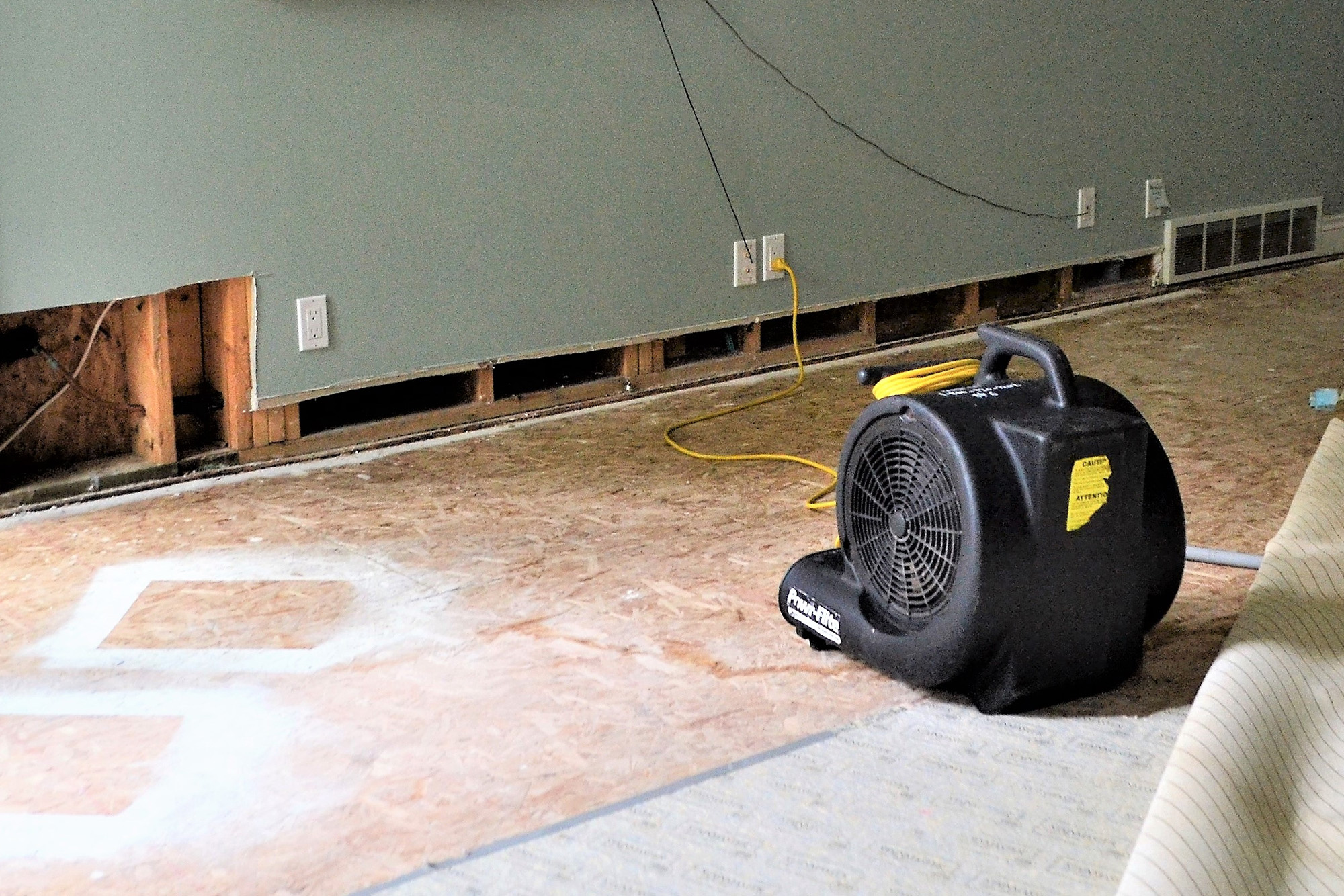 fan drying out water damage in a home